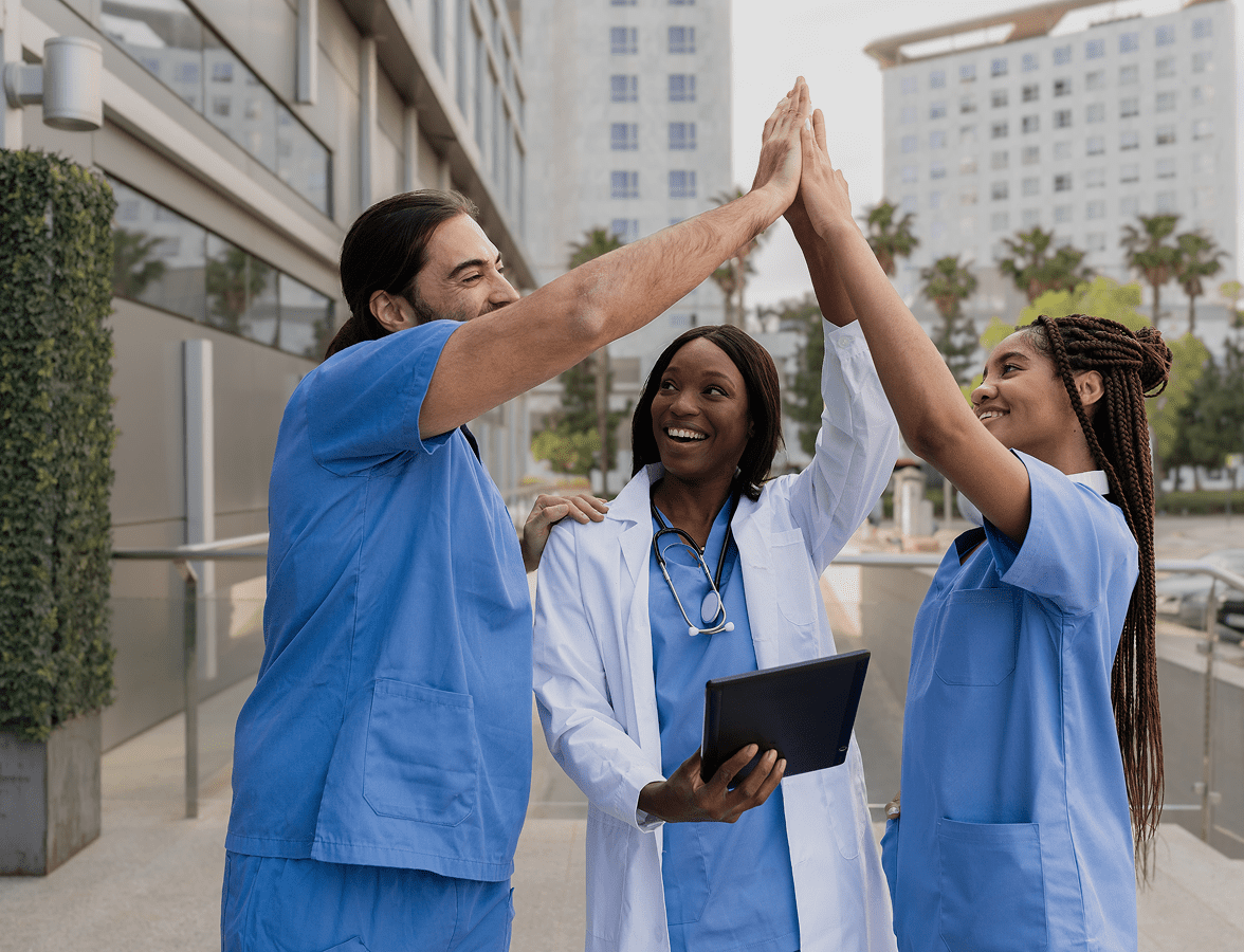 Team of doctors smiling and high-fiving