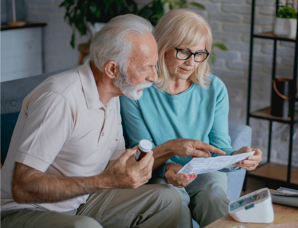 Seniors discussing prescription details at home