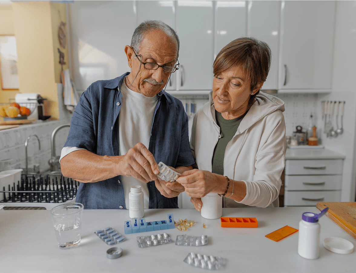 Elderly couple organizing medication together