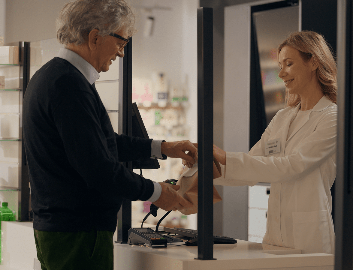 Pharmacist assisting customer at counter