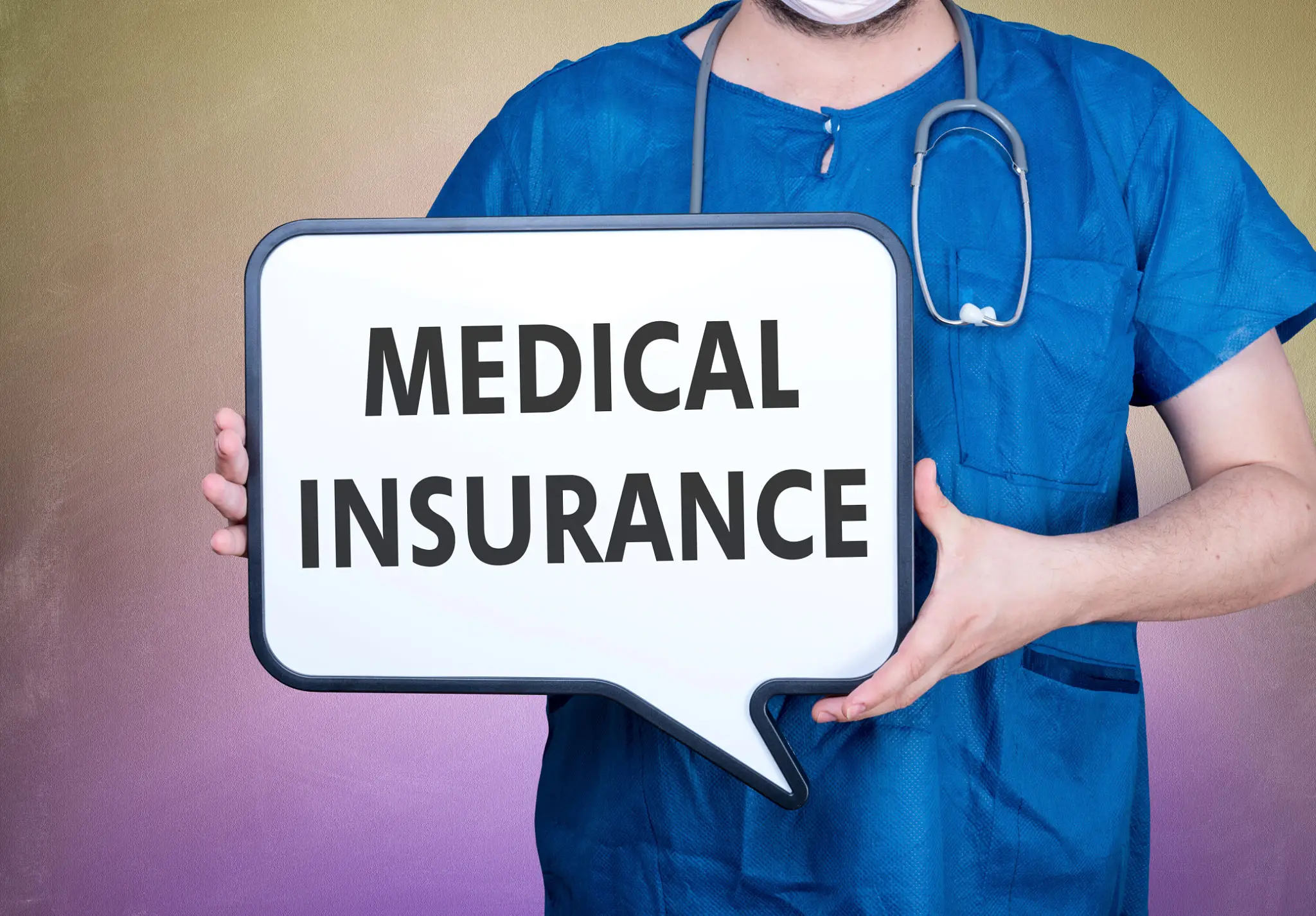 Healthcare professional holding medical insurance sign