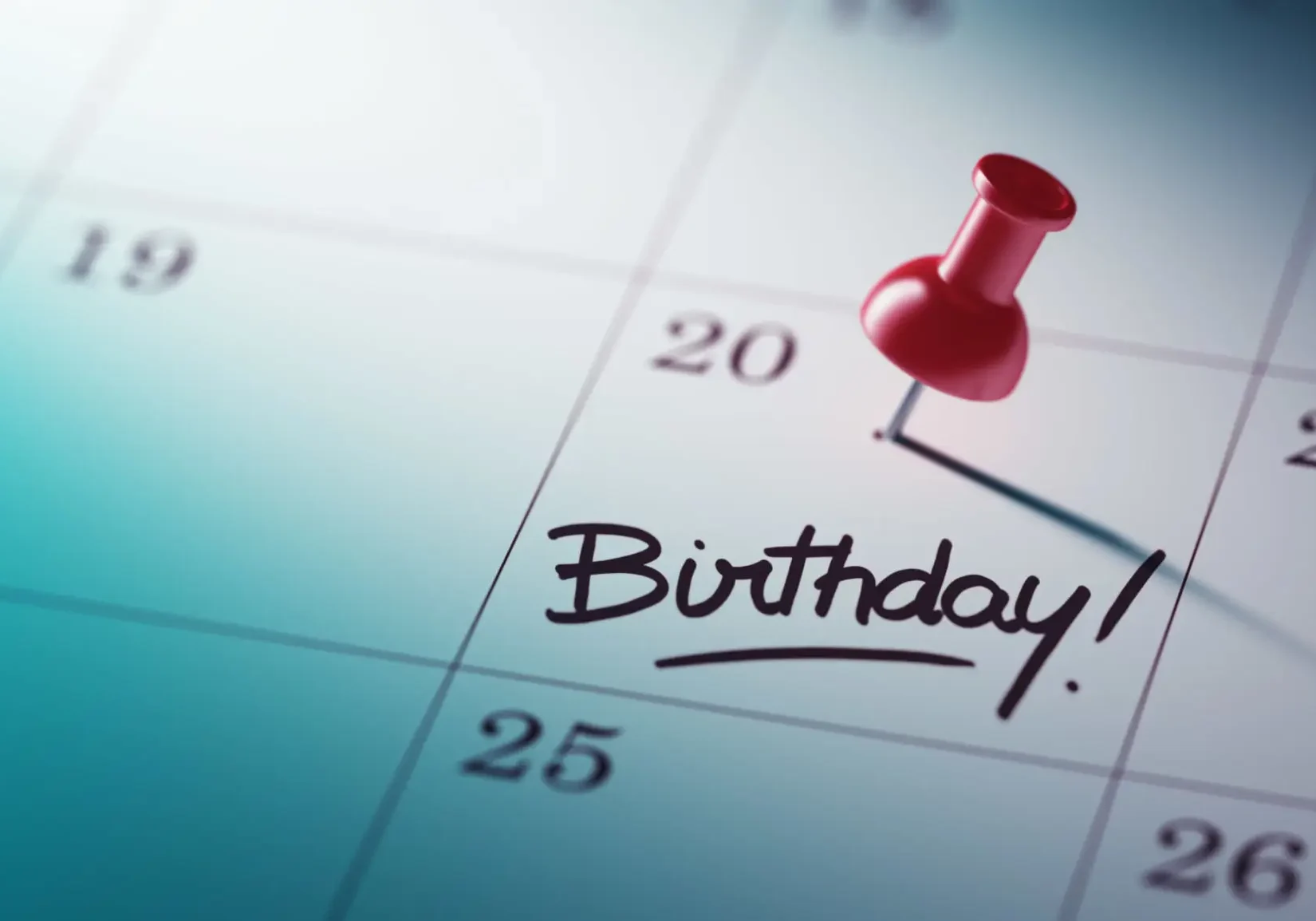 Red pushpin marking "Birthday" on calendar
