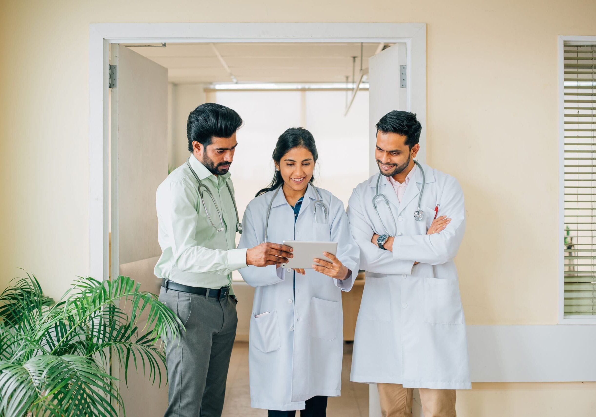 Healthcare team collaborating in hospital hallway