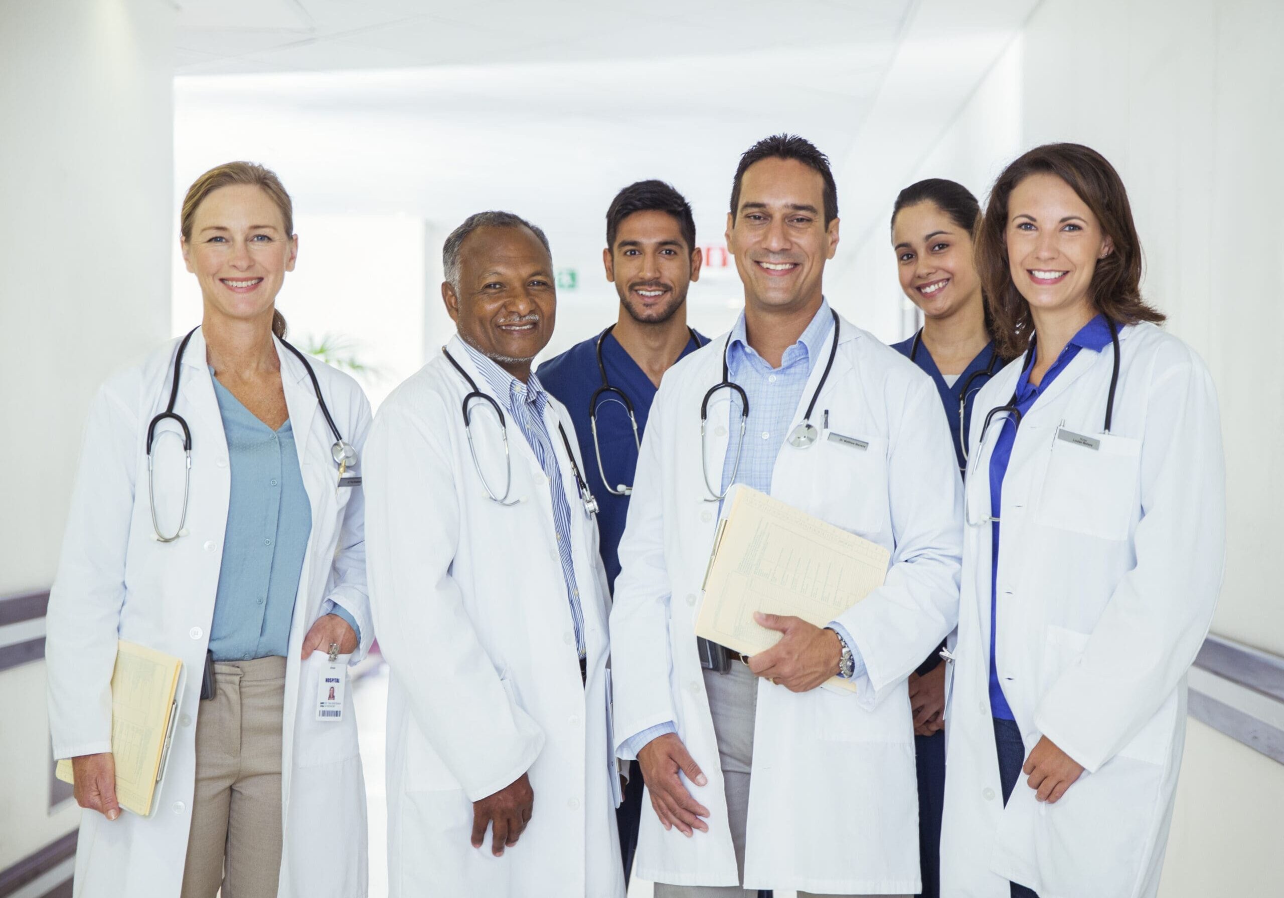 Smiling medical team in hospital hallway