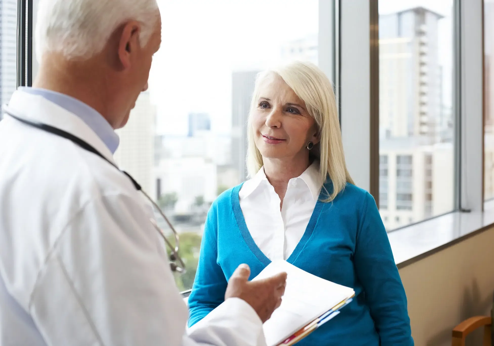 Doctor consulting female patient in office