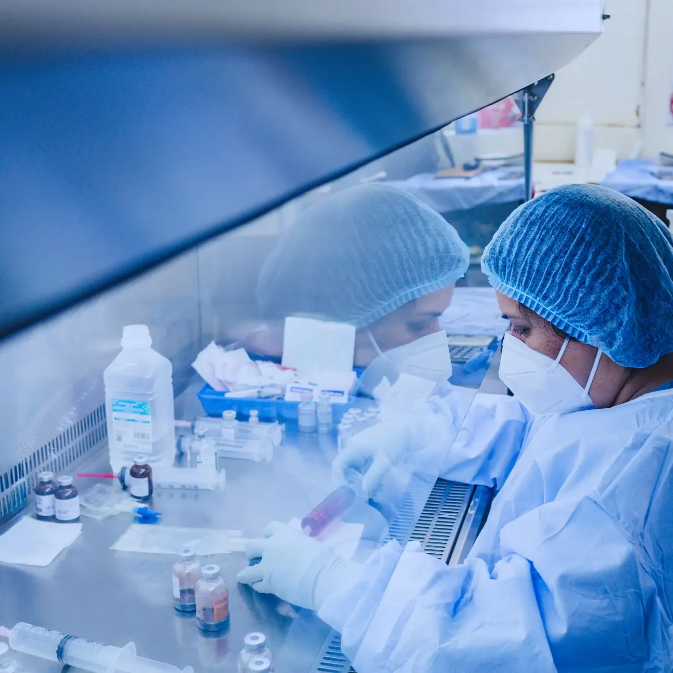 Lab technician working in biosafety cabinet