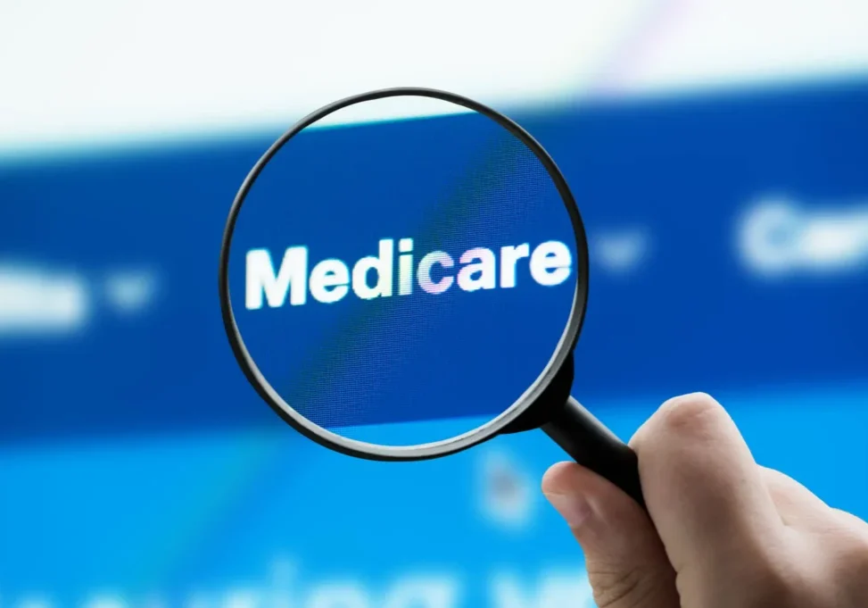 Magnifying glass highlighting Medicare on screen