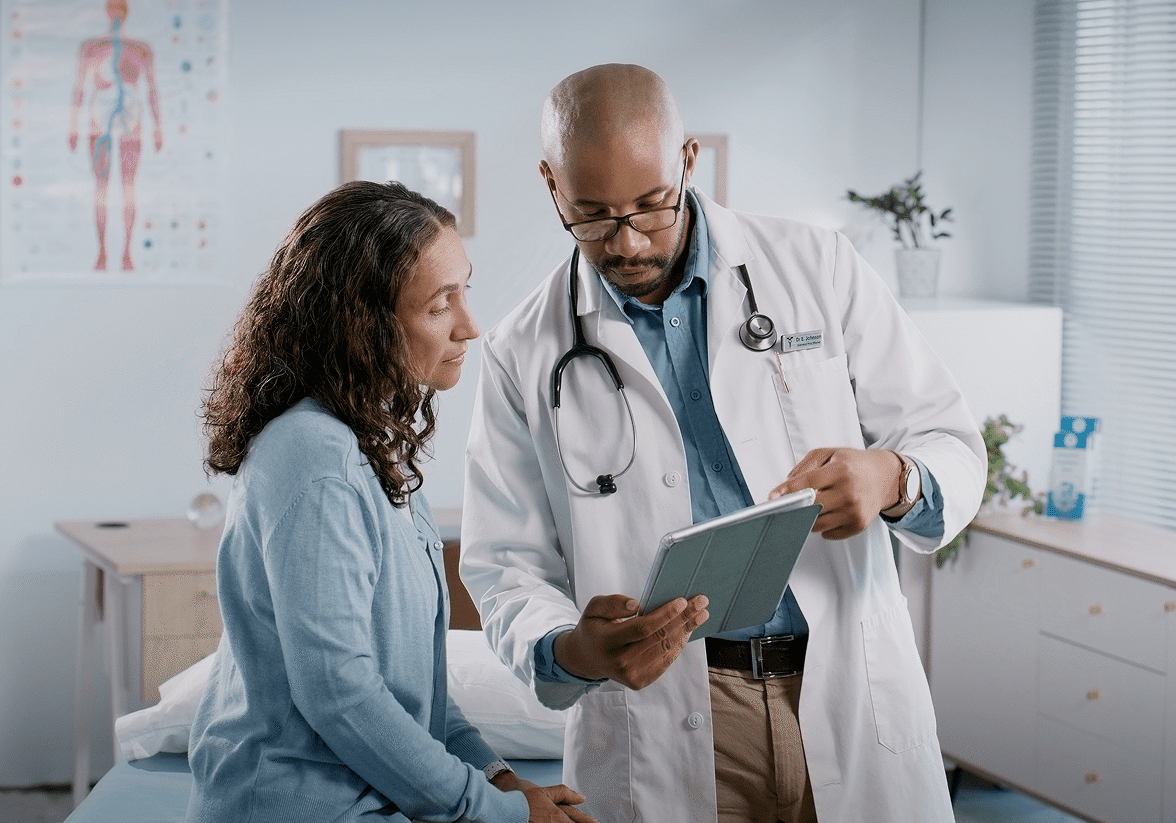 Doctor consulting patient with tablet
